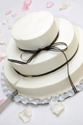 white wedding cake with black ribbon