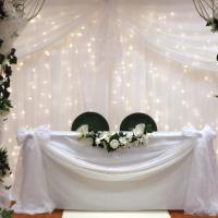 wedding arches with fairytale backdrop and registrar table garlands