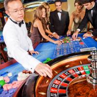 Roulette game croupier and guests