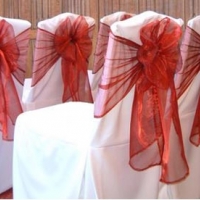 wedding chair covers and red organza sashes