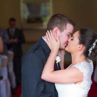 Wedding couple sharing a first kiss