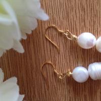 Gold plated sterling silver cultured pearl earrings.