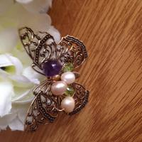 Butterfly brooch with pearl,amethyst and peridot gemstones.