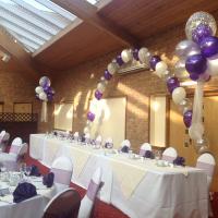 wedding top table set up and balloon arch
