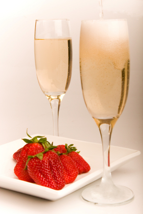 two champagne flutes and strawberries